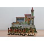 An early 20th century wooden children's fort, hand painted, with removable sections, the base with