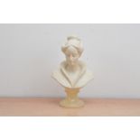 A 20th century art nouveau composite bust of a lady, raised on an alabaster circular plinth, the