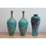 Three early to mid 20th century Japanese enamel and brass vases, a pair with narrow necks, with