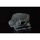 A mid 20th century Lalique clear glass bison, on a rectangular base, the left signed marked