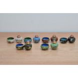 A collection of Japanese cloisonne cruet items, comprising sugar/salt pots, mustard pots, two mother