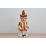 A 19th century large Staffordshire ceramic character jug, of a seated clown/jester, with cover,