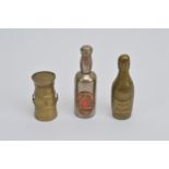 Three Victorian and later novelty vesta cases, comprising two in the form of alcohol bottles, one