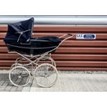A Silver Cross baby perambulator, painted dark blue with white lining, original hood and cover --