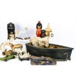 A selection of recent decorative toys, including wooden rowing boat shelf unit, four pull along