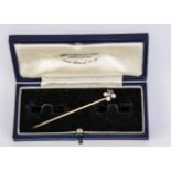 A cultured pearl and diamond flower head style stick pin, on a gold pin with twist 5.5 cm long, 1.3g