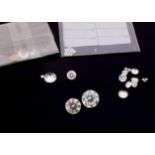A collection of loose colourless faceted cut gemstones, including two Zircons 10 cts approx, small