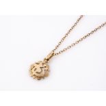 A continental gold 750 marked pendant, cut and pierced design, on a 9ct gold fine chain, 22 cm