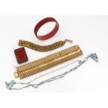 A Chinese cinnabar lacquer bangle, a silver backed clip brooch in Chinese cinnabar, together with