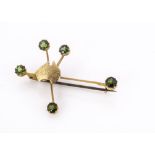 A 15ct gold and peridot Australia brooch, centred with an outline of the country with an outline