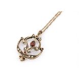 A 9ct gold garnet and seed pearl pendant, of open design set with pearls marked to reverse, 375,