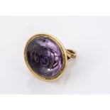 A 19th century amethyst yellow metal seal, oval shaped base, domed top with lyre pierced section and