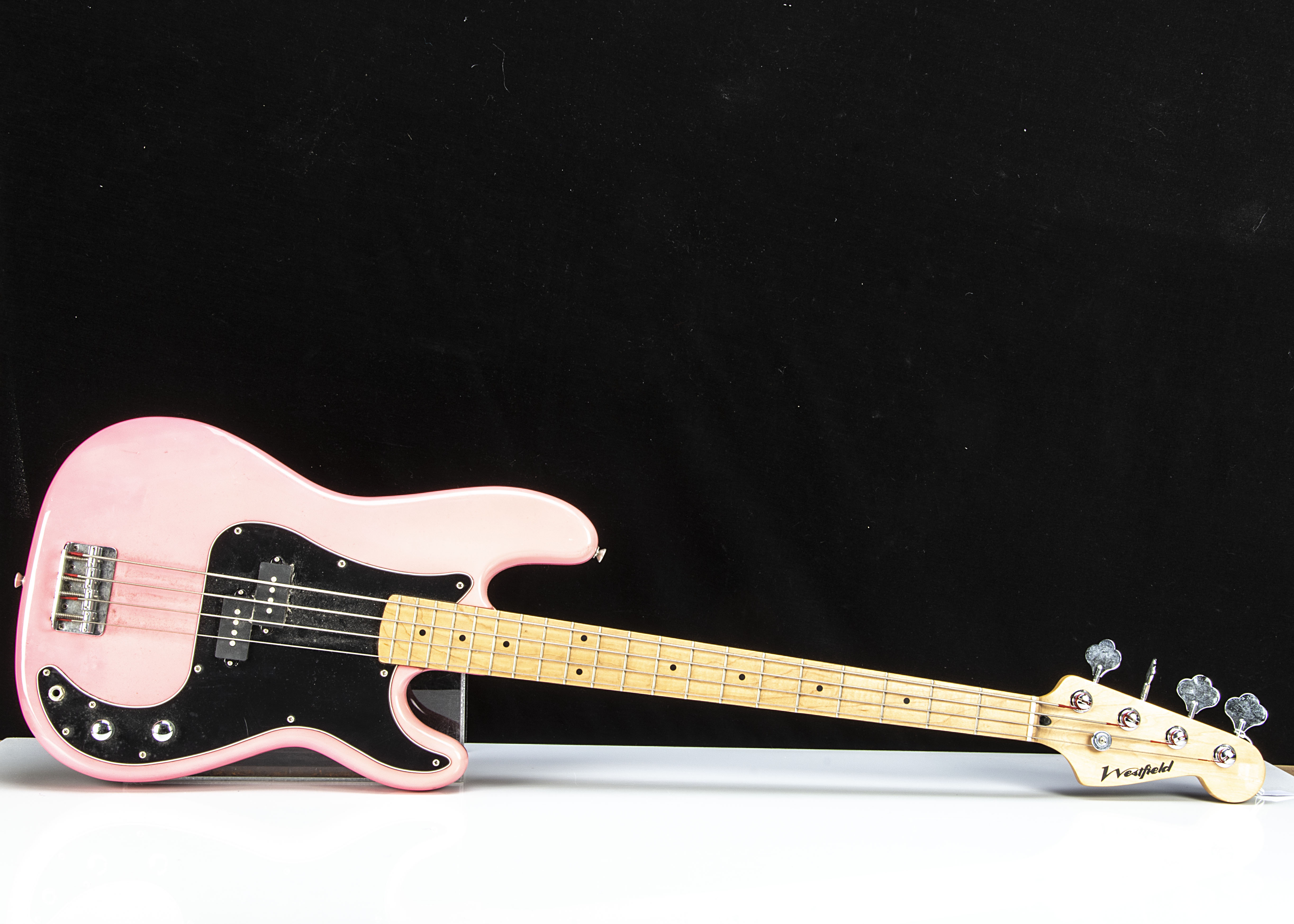 Westfield Bass Guitar, a Westfield Bass Guitar in pink with black pick guard, good condition with