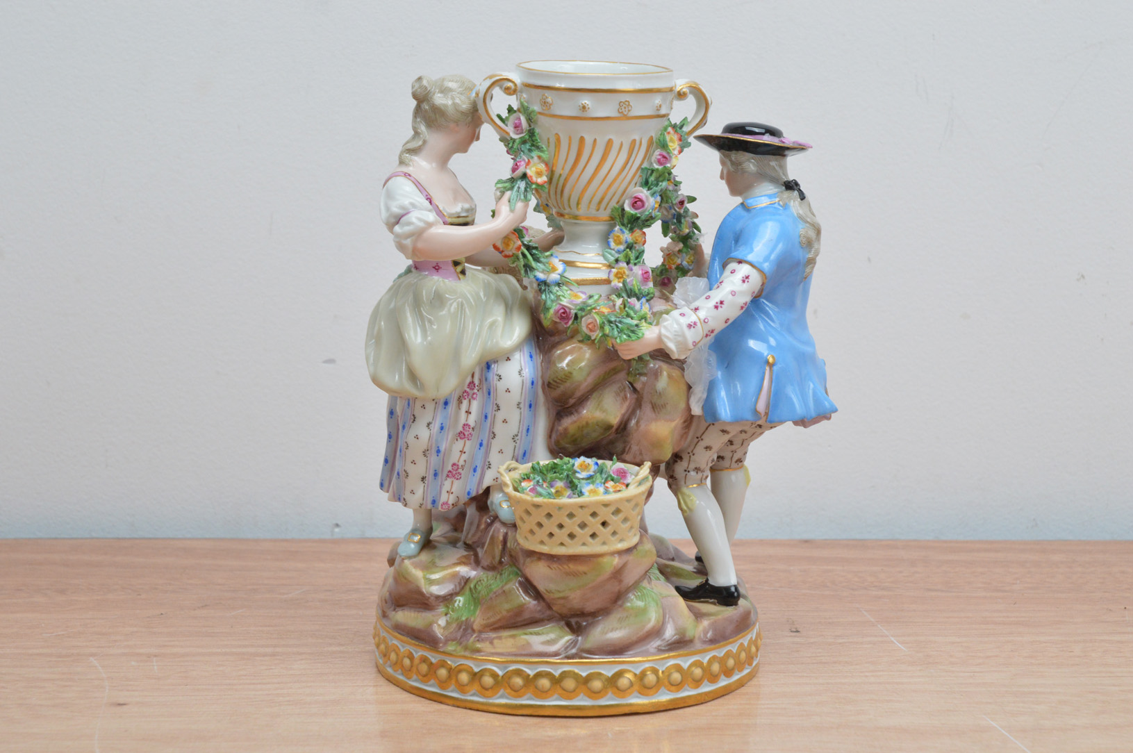 A 19th century Meissen porcelain figural group, of a man, woman and child surrounding a twin handled - Image 2 of 3