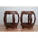 A pair of modern Chinese wooden barrel stools, 48cm high, together with a Chinese Library set of