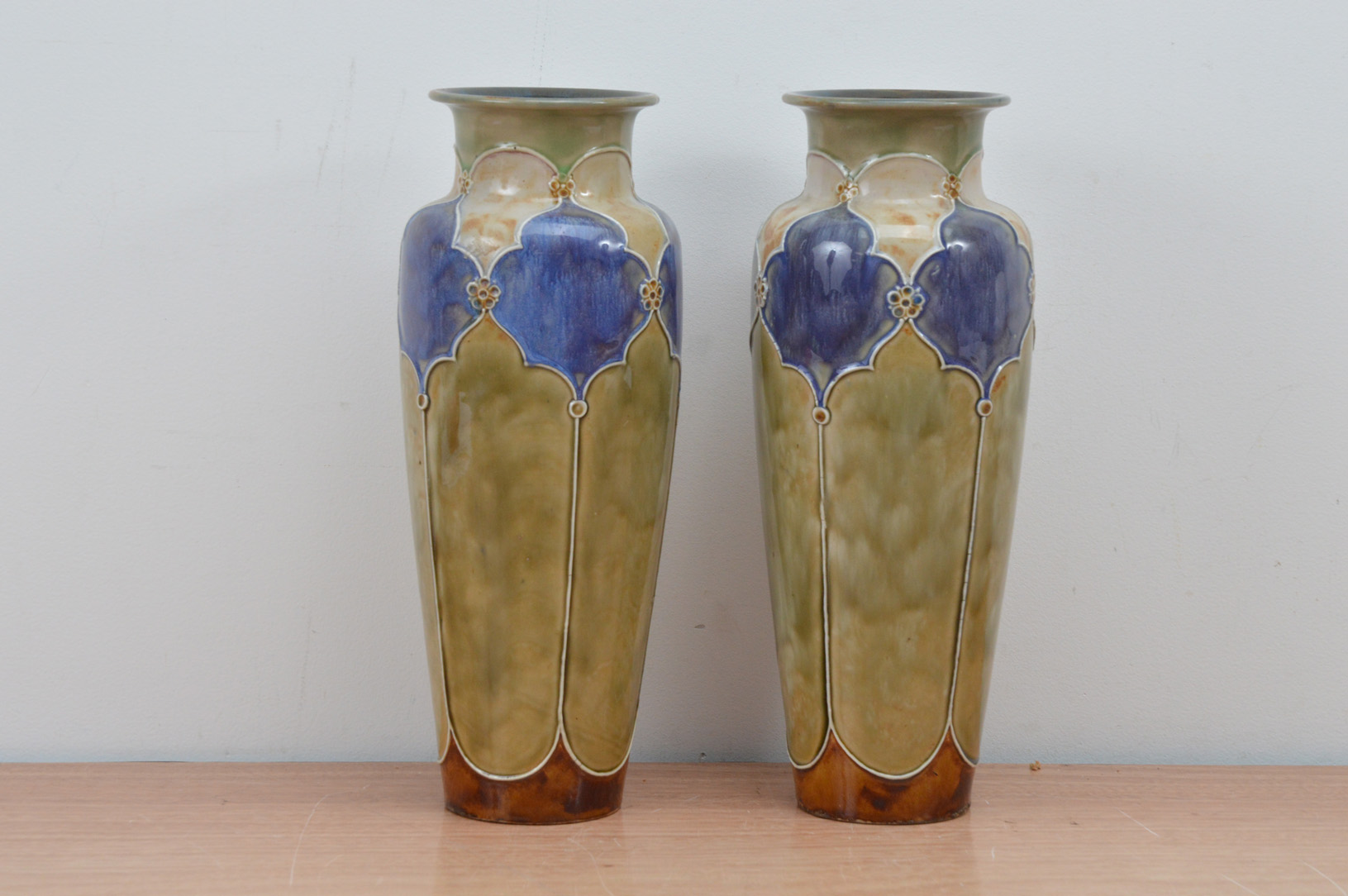 A pair of Royal Doulton stoneware vases, with green and blue design, both with imprinted marks to