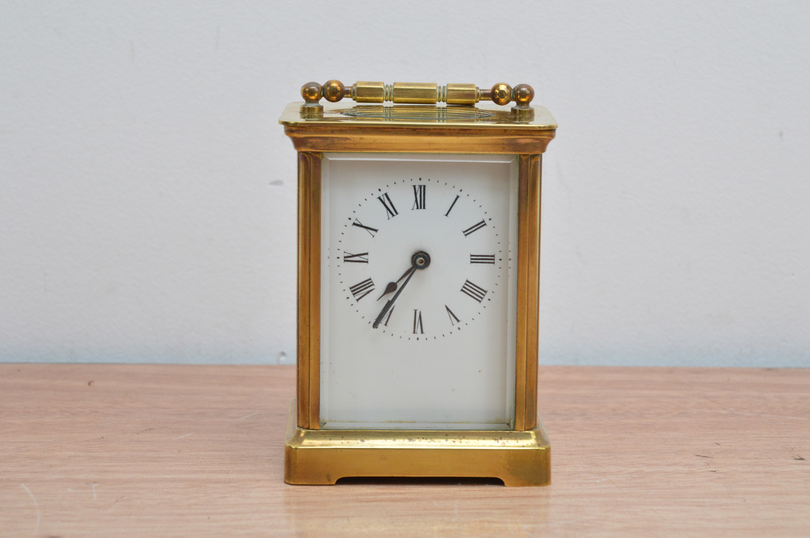 A turn of the century brass French carriage clock, by A.C.C., and marked to the reverse, white