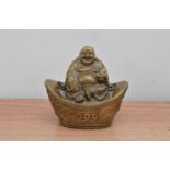 An early 20th century brass Buddha, sitting atop a shaped base, with raised dragon design 12cm high