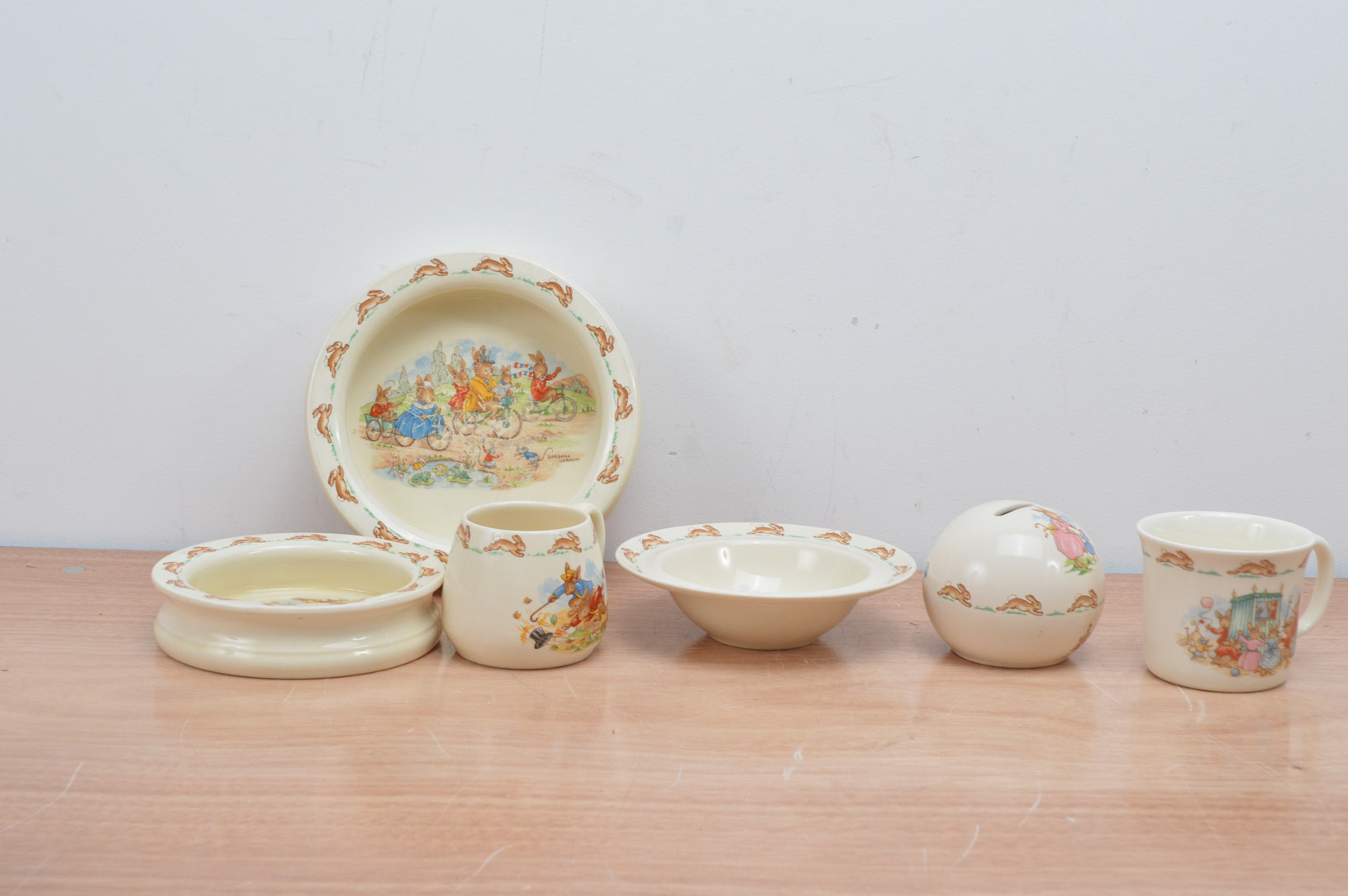 A collection of Royal Doulton bunnykins ceramics, comprising three different shaped bowls, a money