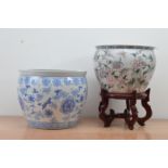 Two 20th century Chinese ceramic fish bowls, one with a blue and white design, the other a floral