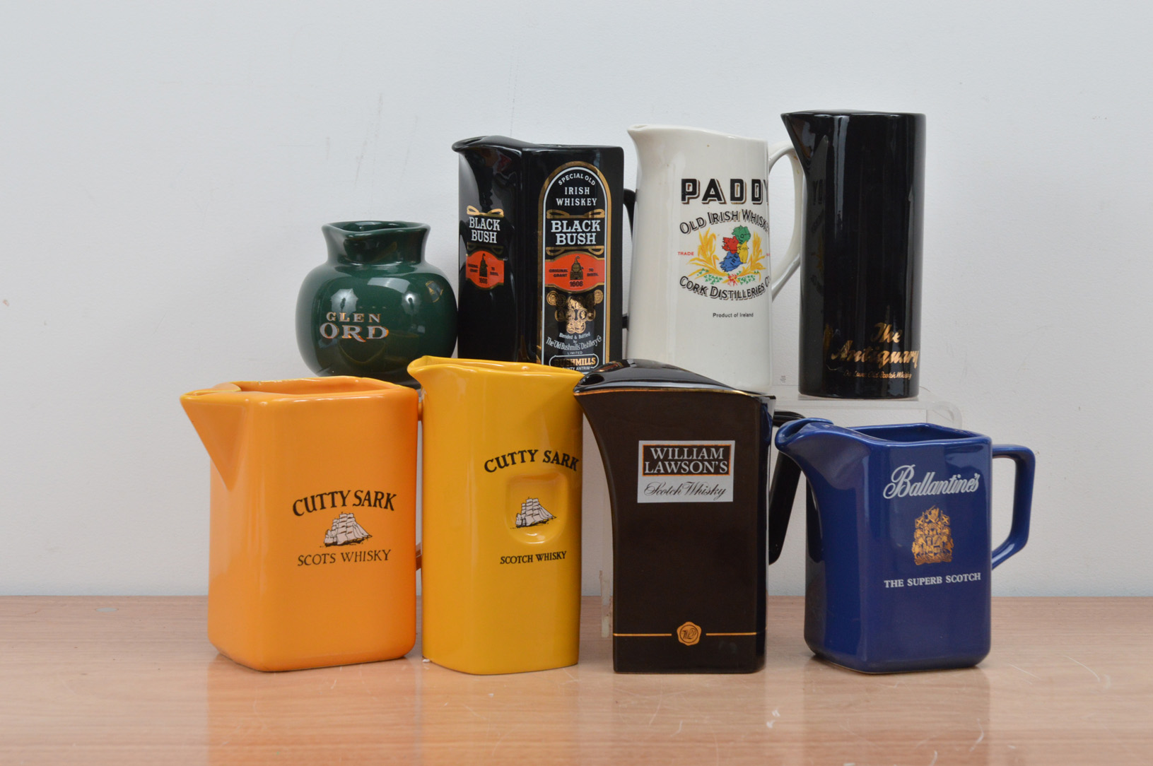 A collection of eight ceramic branded water jugs, comprising two Cutty Sark, Glen Ord, Black Bush,