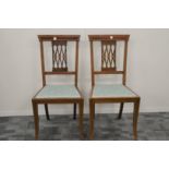 A pair of Edwardian mahogany and boxwood inlaid occasional chairs, in the 'Sheraton' style, the