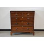 A Victorian oak crossbanded chest of drawers, two short drawers, over three graduated long