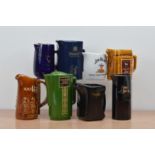 A collection of eight ceramic branded water jugs, comprising Seagram's 100 Pipers, Seagram's VO,
