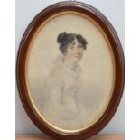 A 19th century Portrait of a young lady, Charcoal on paper, in a oval frame, the reverse with a hand