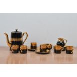 A 20th century Gibson & Sons late Sevres Davenport ceramic tea set, black with gilt design, for six,