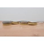 Two hallmarked silver dressing table brushes, together with two pewter examples (4)