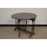 A Victorian ebonised and hand painted Sutherland table, the oval top with a painted floral border,