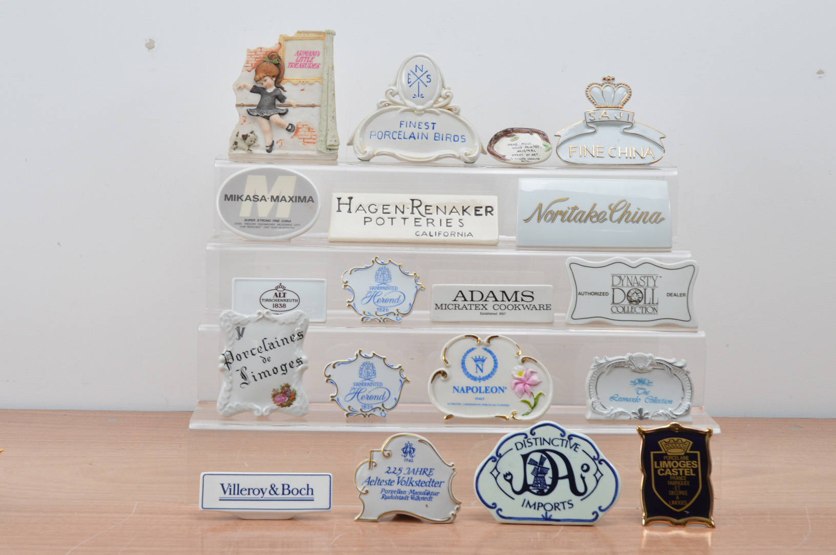 An assorted collection of ceramic advertising plaques, mostly continental, including Limoges,