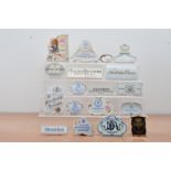An assorted collection of ceramic advertising plaques, mostly continental, including Limoges,