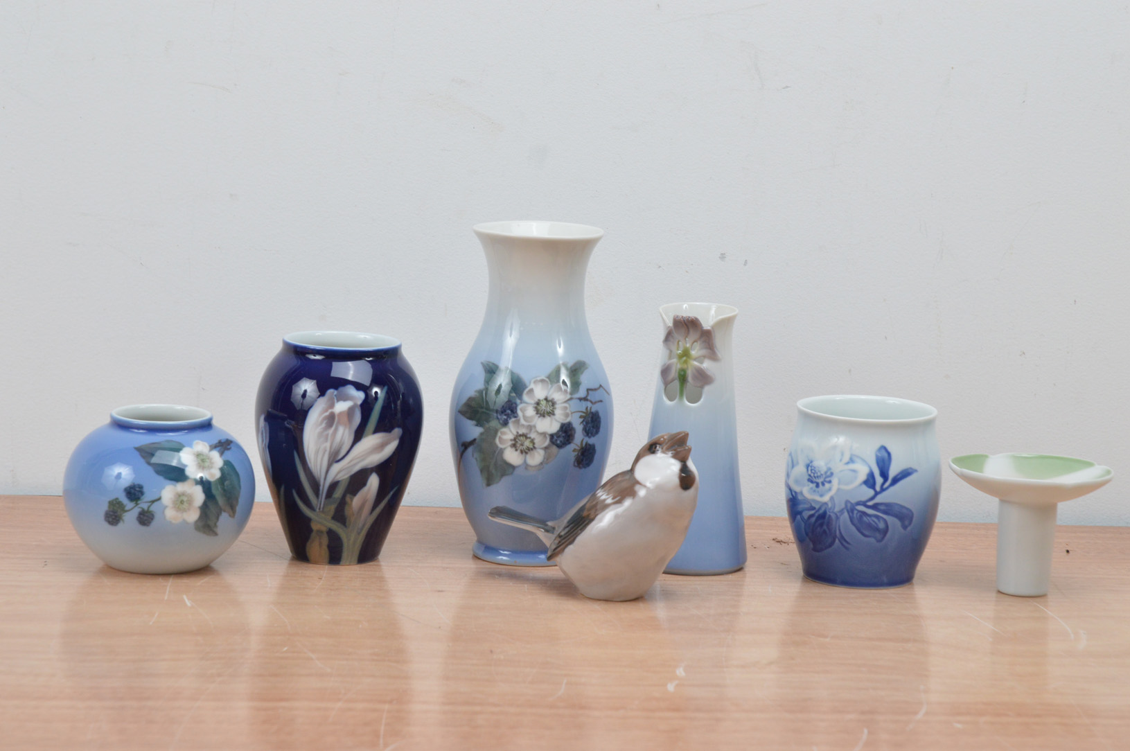 A collection of Royal Copenhagen and B&G porcelain items, comprising vases, and a bird, of differing