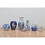 A collection of Royal Copenhagen and B&G porcelain items, comprising vases, and a bird, of differing