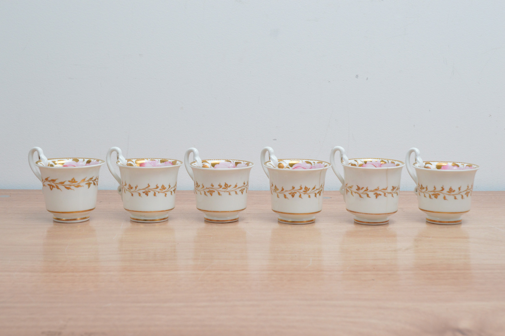 Six early 19th century Spode porcelain tea cups, hand painted floral design with gilt work on a