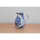 An unmarked 19th century English blue and white porcelain jug, with main floral design, a firing