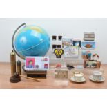 A large collection of collectables, including a modern globe, a shell, coin covers, paragon and