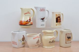 Five ceramic The Famous Grouse water jugs, together with a Laird's and Pride of the North example,