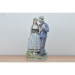 A large Royal Copenhagen porcelain figural group, of a husband and wife, marked to the underside