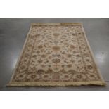 A modern woollen rug, ivory colour, some wear, 130cm x 190cm