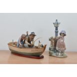 Two Llodra ceramic figural groups, comprising a father, son and dog on a fishing boat, with a wooden