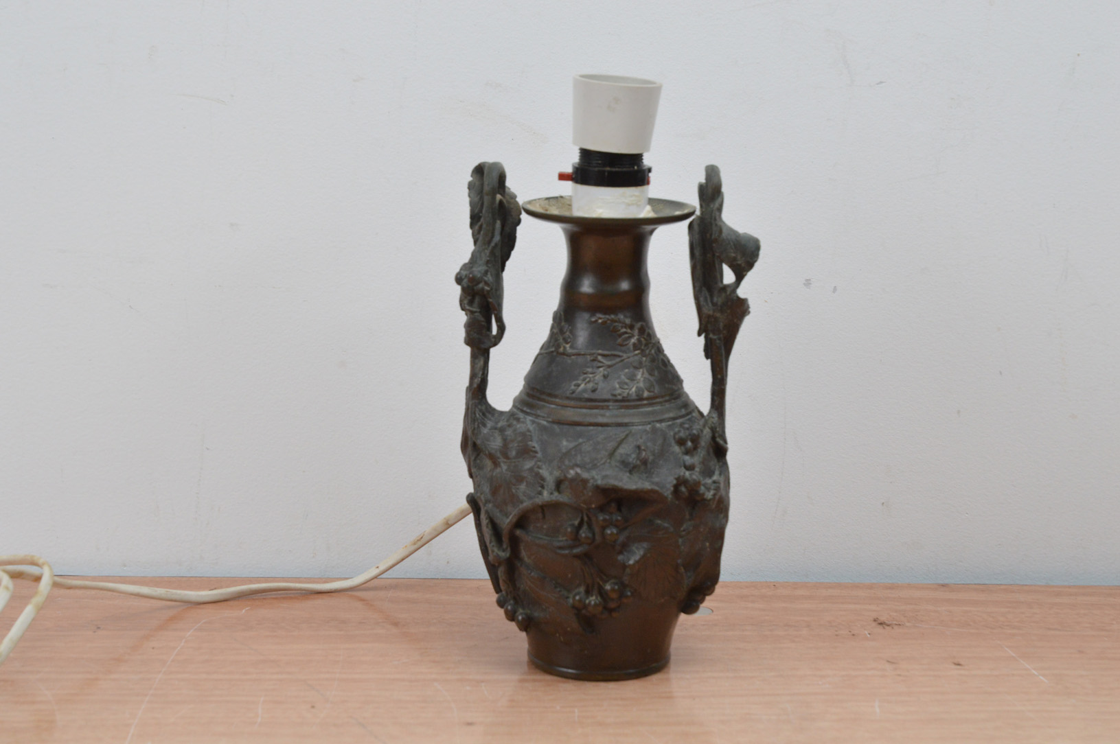 A French bronze twin handled vase, converted to an electric lamp, with bird and foliage