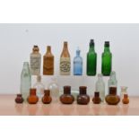 A collection of glass bottles, including chemist examples, together with three ceramic Ginger Beer