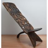 A late 19th/early 20th century East African hardwood tribal chair, two part construction, the back