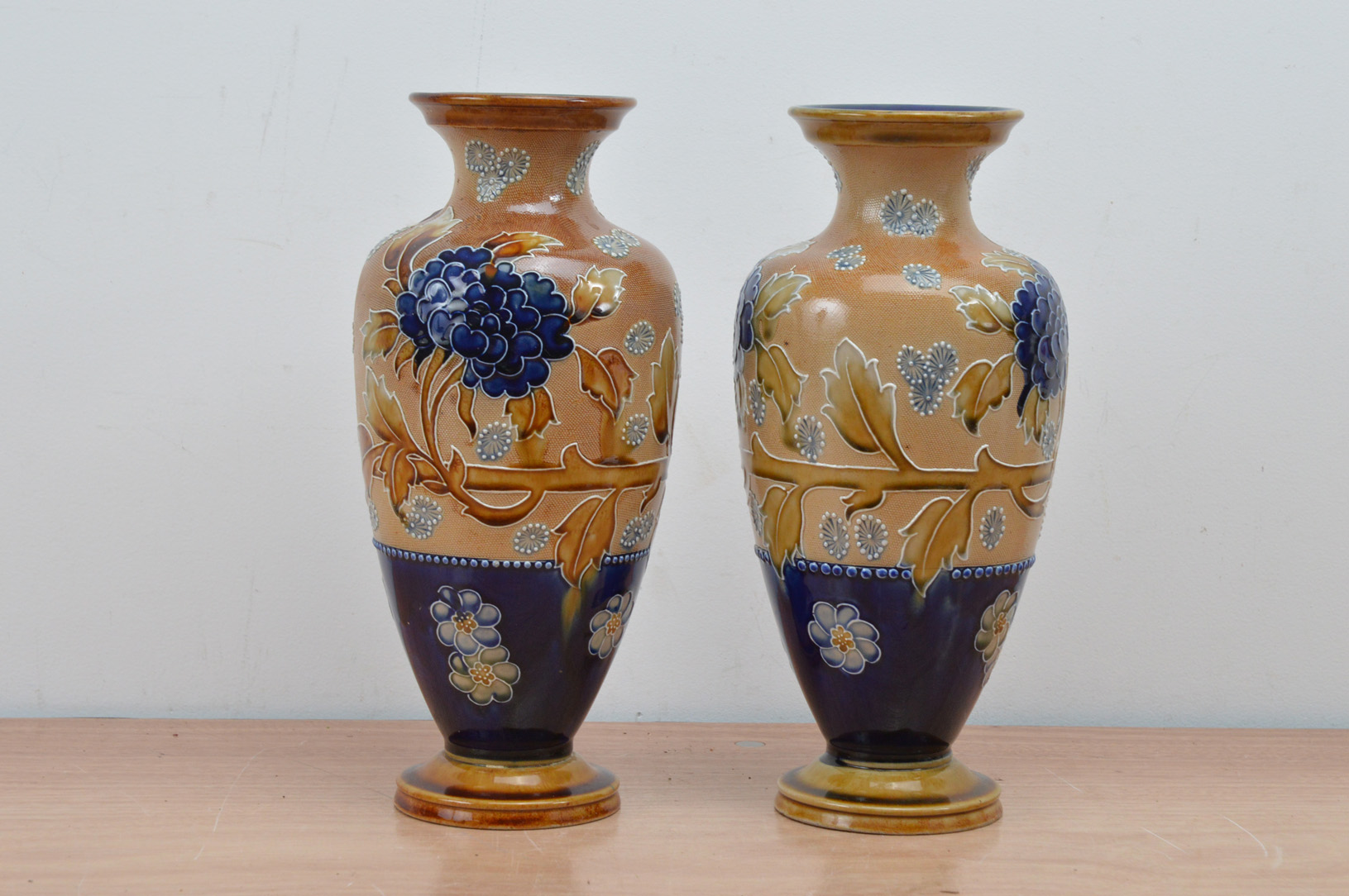 A pair of Doulton Lambeth stoneware vases, blue and brown decoration, both with impressed marks to