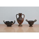 Three antique terracotta vessels, comprising amphora example 13cm high, and two smaller twin handled