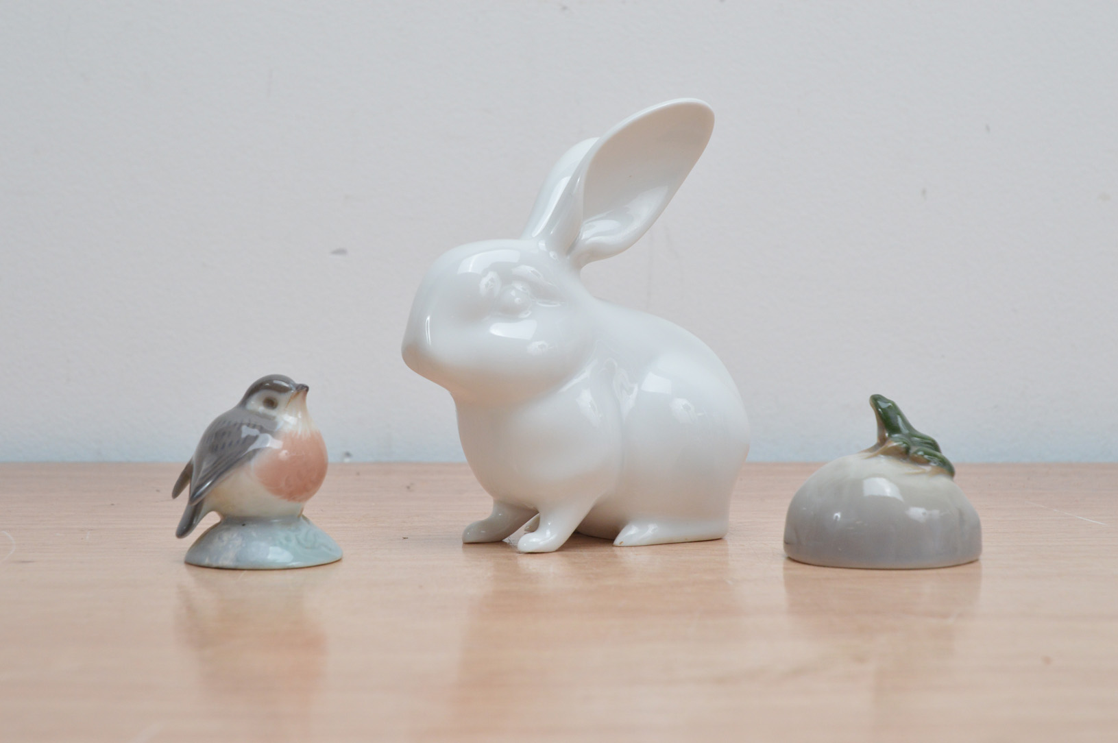 Two porcelain Royal Copenhagen animal figurines, comprising a bird and frog on a rock, both marked