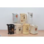 A collection of seven ceramic Whiskey branded water jugs, comprising Queen Anne, Bowmore, Jameson,
